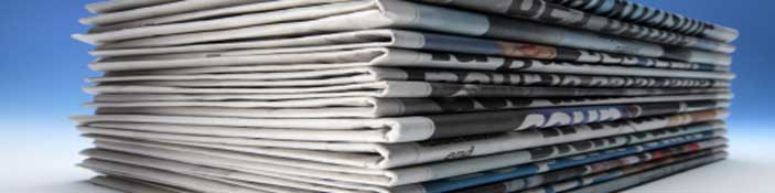 press release - banner pile of newspapers